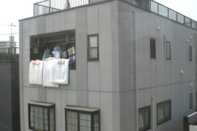 ....you'd see the apartment buildings, which housed hundreds of families, all decked out with their bedding hanging over the sides.  Saturday was cleaning day for most of Tokyo.  There are even little clips especially made to make sure your bedding doesn't slide off the rail and onto the ground below.