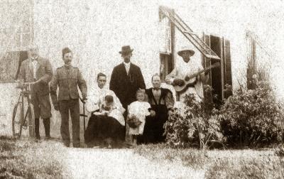 From Left to Right :-
George Leaman (with bike - Mary Eliza Barritt's son-in-law), 
Benjamine Barritt (In his Bermuda Volunteer Uniform - Mary Eliza Barritt's son), 
Jane Eliza Barritt (Benjamin Barritt's Wife), 
Horace (Hoddie) Barritt (Mary Eliza Barritt's son), 
Walter Barritt (With Guitar - Mary Eliza Barritt's son), 
Mary Eliza Barritt, Hyacinth Barritt (Benjamin Barritt's Daughter about 5 years old), 
Ruby Barritt (Benjamin Barritt's Daughter) 
and 
Nelson the dog.

This is what is written on the back of the photo in my Grandmother's  handwriting. (Mary Elizabeth Hyacinth Barritt) 