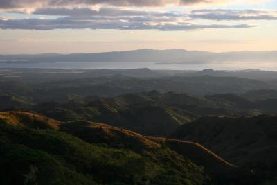sunset in the mountains of Monteverde, with Pacific Ocean visible in the distance