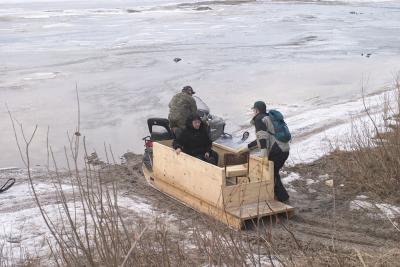 Getting the skidoo taxi onto the river