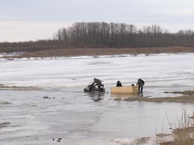 Skidoo taxi in water along edge of ice