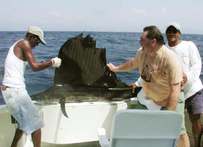 Larry lands a sailfish, Pias Bay, Panama, 1-2003