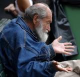 Old man  at Quay talking to pigeons