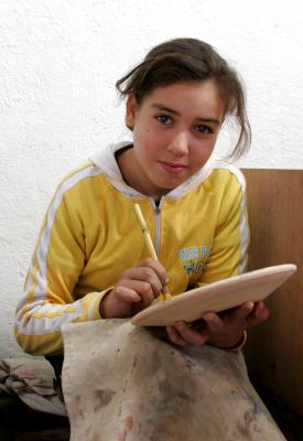 Young Girl Painting Pottery