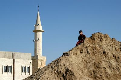Boy playing on a mound of dirt, Karak