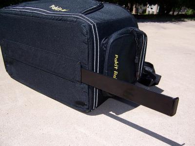 The locking bar slides into a panel in the bag to secure it to the tray