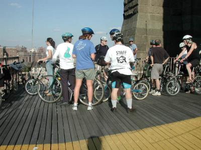 Ride leader Hannah Borgeson,conversing with unidentified STAFF member at the Manhattan tower of The Brooklyn Bridge.  Look at that sky!  Mother Nature sent a beautiful day.