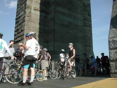 On The Brooklyn Bridge's viewing platform, NYC veteran cyclist Danny Lieberman explains to a visiting out-of-town rider that ...It's all down hill from here!