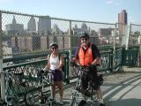 Brooklyn-bound on the Manhattan Bridge's bike and pedestrian path, a smiling Sharon Anstey on her Microbike with TU's John Chiarella on his Dahon.