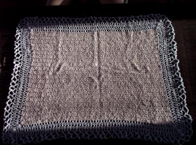 Hard to tell but this blanket was a pale baby blue square with medium edging.