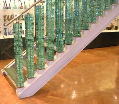 Glass staircase that became a balcony at the top of the stairs