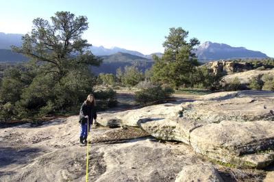 Measuring ... looking south across our back yard rocks