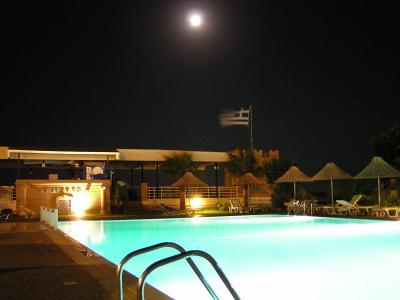 Night with full moon at the pool