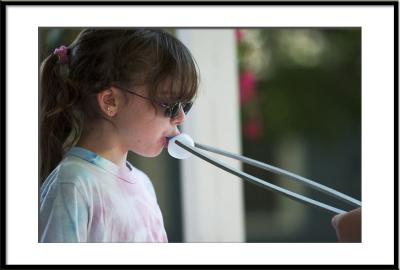 ...it isn't easy blowing a big one, but this little girl does pretty well.