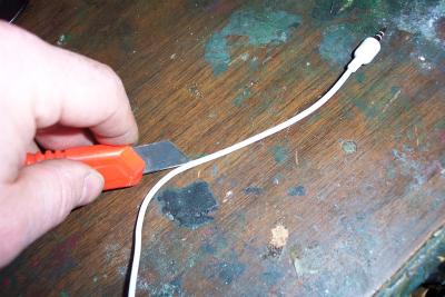 Here I carefully sliced open the sheath on the remote cable to extract the audio wires