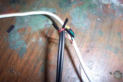 I spliced the audio wires into a seperate female mini plug connector. Red is GROUND, Black is LEFT and WHITE is RIGHT channel.