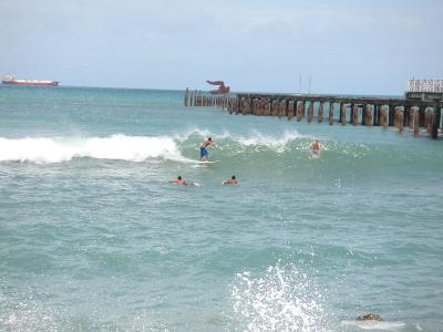 Surfing next to the pier