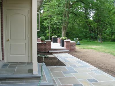 bluestone stoop and walk with walled patio behind