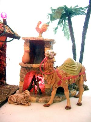 The Magis' camel (added in '01) and one of the sheep warm themselves by the fireplace