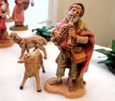 One of the shepherds (added in '01) plays his flute for the family and their guests