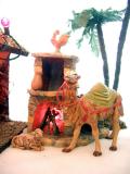 The Magis camel (added in 01) and one of the sheep warm themselves by the fireplace