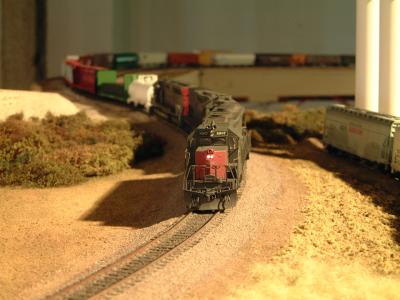 Southern Pacific Freight train glides through scenery representative of Northern California