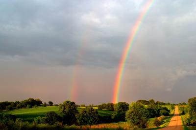Double rainbow over gravel road