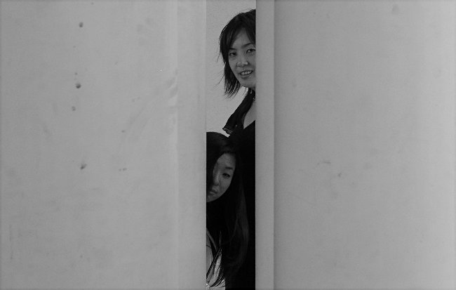 Two Japanese Girls Behind Columns<br>