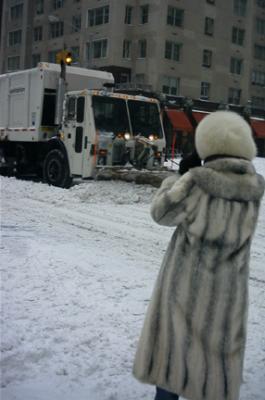 Tourist taking picture of snowplow