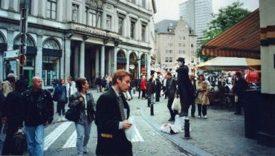 A mime  and the entrance to the Galeries Royales St. Hubert in the background.