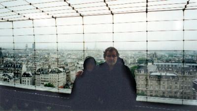 Richard and a mysterious hooded person in the shadows at the top of the Tower of the Cathedral of Notre Dame - in the rain.