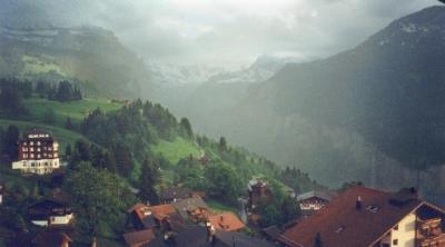 View of Wengen from our hotel room balcony.. The Lauterbrunnen valley (right side) and the Alps are in fog and clouds.