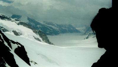 Judy (silhouette) observing the Aletsch Glacier from the top of Jungfrau. Glacier is a 14 mile river of ice (longest in Europe).