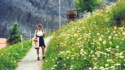 Judy picking wildflowers on a trail in Gimmelwald. (1)
