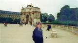Judy near the Arc du Carrousel in front of the Louvre. The Eiffel Tower is seen faintly in the background.