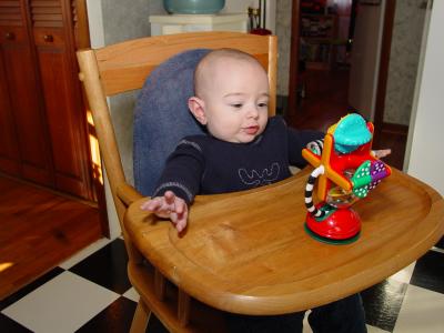 His first time sitting in a high chair