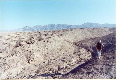 The line of holes runs straight through the coastal desert and up/down the Andean foothills