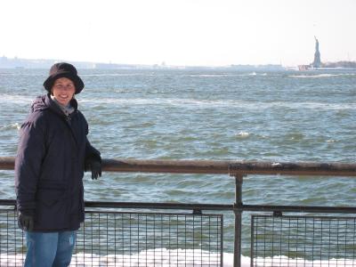 Chelle poses with the Statue of Liberty in the background.