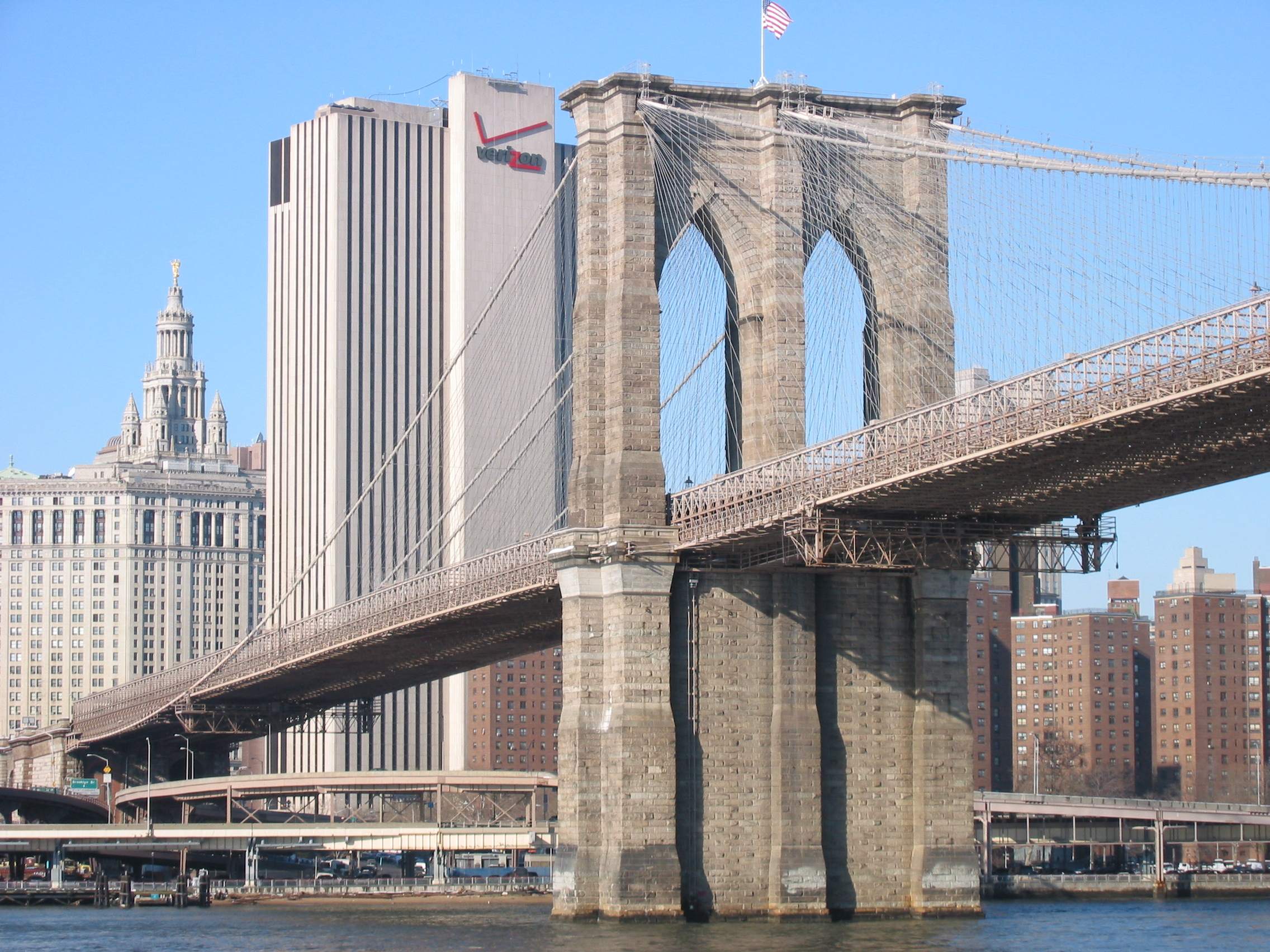 View of the Brooklyn Bridge with the Verizon building in the background.