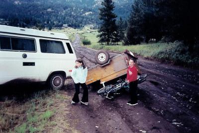 Oops, had a little mishap going up the rain-slickened Dearborn Road. Darn, those were the kids' new bikes! Check out those sad faces. We're not there yet!