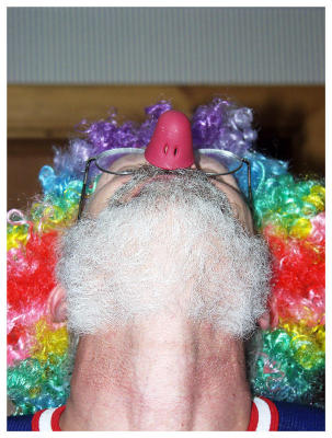 Clown shows his nose.