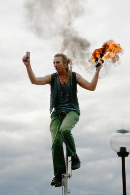 Fire juggler on monocycle