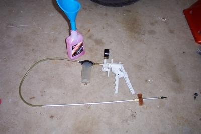 Mity Vac tool with homemade alluminum rod and rubber tip and stop block used to set fork oil level