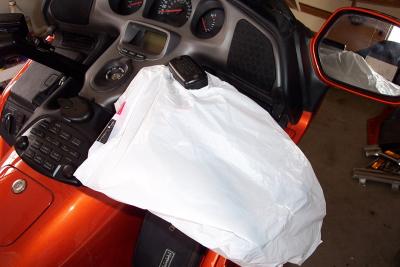 I simply made a small hole in a plastic bag and then stretched it over my master cylinder.