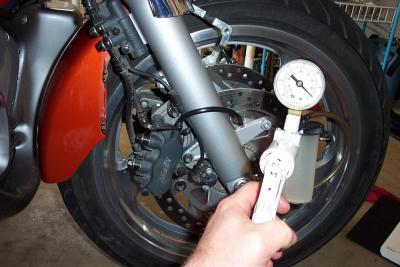 Here I open the right UPPER valve and begin drawing out the old fluid. Monitor the master cylinder and keep it full