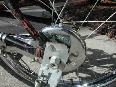 Rear drum brake housing is thick enough to drill and tap threads into it. (note the jam nuts).  Look more closely.  it says: TOKYO.  With no front brakes and just this drum brake on the rear wheel, you had better have an advance plan for stopping.