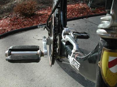 Camera angle illustrating the sweep of the down tube, a view of the latch and the protuberance of the through-axle shifter fulcrum.