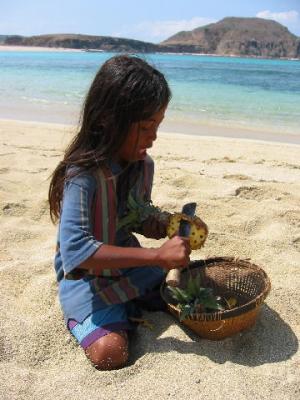 getting a pineapple cut up on the beach for a snack