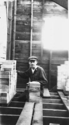 Frank, in house Sam built, in 1929 piling up bricks and points for forthcoming marriage