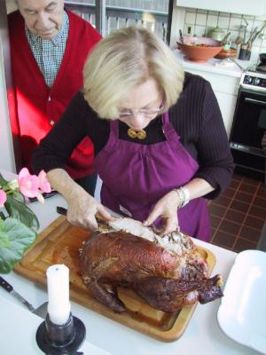 Mrs. Goldberg cutting the turkey